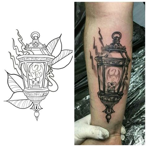 a black and white photo of a lantern tattoo