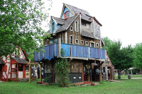 an old wooden house with blue balconies on the roof