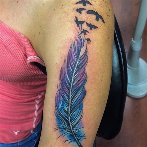 Great big colorful feather bird tattoo on upper arm - Tattooimages.biz