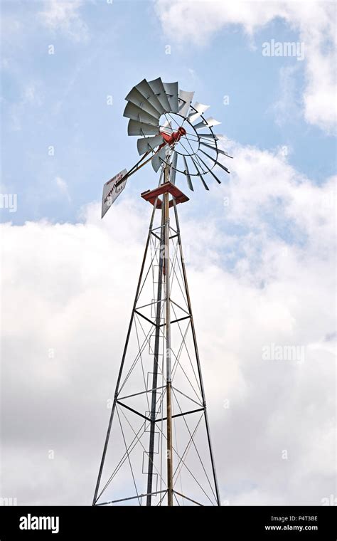 Old farm or ranch windmill water pump pumping water for agriculture in rural Alabama, USA Stock ...