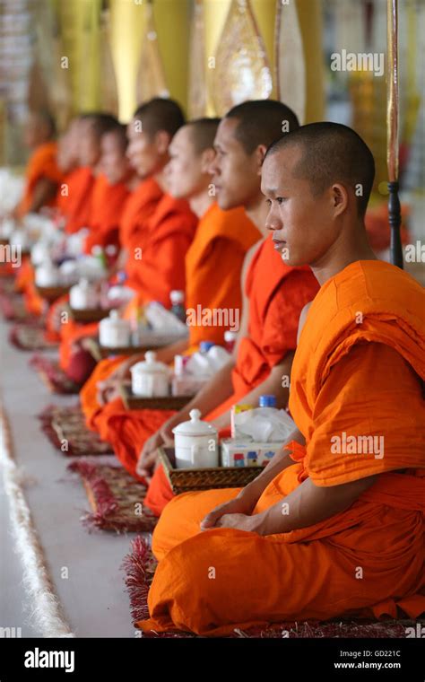 Seated Buddhist monks chanting and reading prayers at a ceremony, Wat Ong Teu Buddhist Temple ...