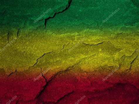 Red, yellow, green rasta flag on stone wall — Stock Photo © nattapol ...