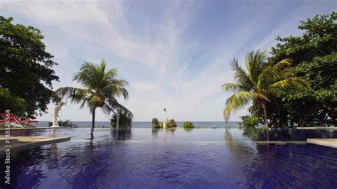 Luxury hotel,resort near at sea with pool among the palm trees. Luxurious open air swimming pool ...