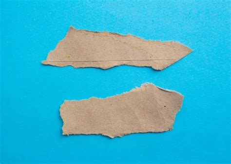 Premium Photo | Torn brown paper on a blue background