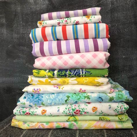 a stack of folded cloths sitting on top of a blackboard covered in flowers