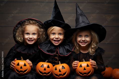 Cute little kids dressed in costumes witches for Halloween against wall ...