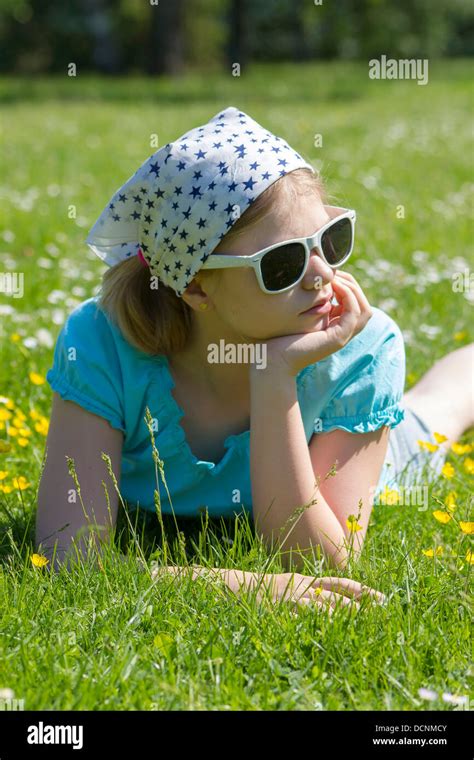 little girl lying on grass Stock Photo - Alamy