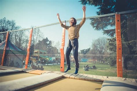 Premium Photo | Man jumping on trampoline at playground