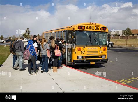 High School Students board a school bus for the trip home from school Stock Photo, Royalty Free ...