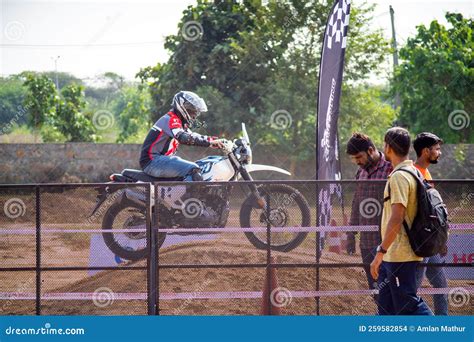 Spectators Watching Off Road Bike Racing Event with Xpulse Bike Going Over Jump Behind Fence ...