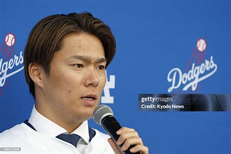 Newly signed Los Angeles Dodgers pitcher Yoshinobu Yamamoto speaks as ...