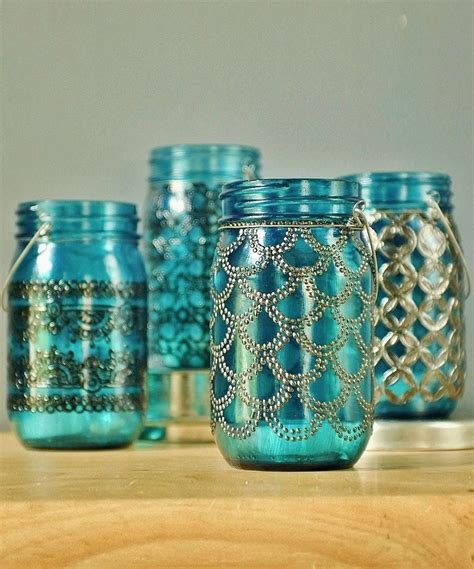 This hanging lantern is hand painted in henna–like detail on sea-glass-colored mason jars ...