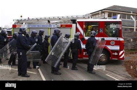 Specialist prison officers escort fire fighters in to HMP Ford near Arundel, West Sussex after ...