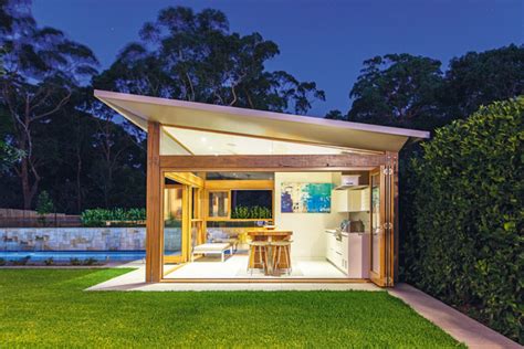 A contemporary cabana ties together this decadent pool and backyard