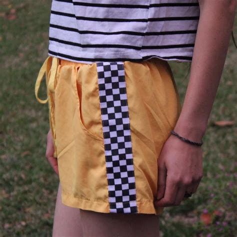 Yellow basketball shorts with checkered stripes on... - Depop