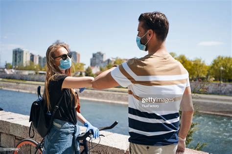 Young Couple Handshaking With Elbows During A Coronavirus Pandemic High ...