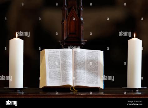 Church candles and open bible on an altar. Strasbourg. France Stock Photo - Alamy