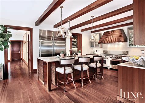 Contemporary White Kitchen with Exposed Wood Beams - Luxe Interiors + Design