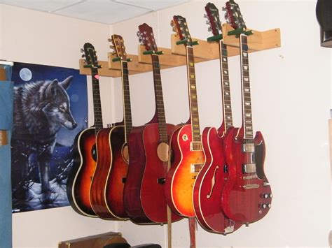 wall mounted guitars | Guitar hanger, Guitar storage, Guitar storage cabinet