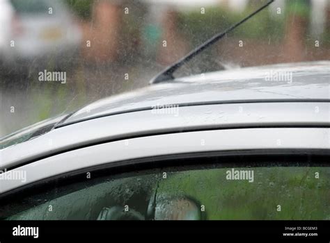 Heavy rain on car roof Stock Photo - Alamy