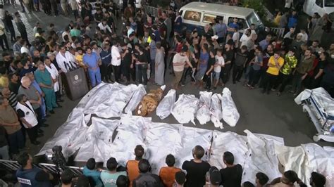 Bodies line up outside Gaza hospital as Israeli airstrikes continue - YouTube