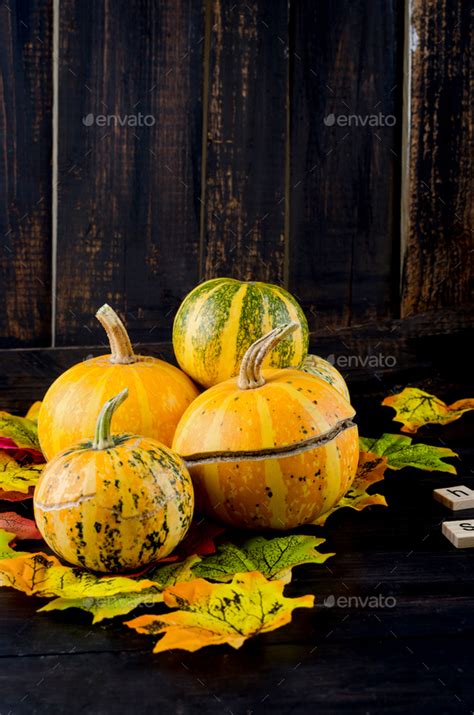 autumn dark background with pumpkins and leaves Stock Photo by Viktoriyamart