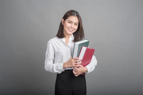 Beautiful teacher Woman holding book on grey background Photo | Premium Download