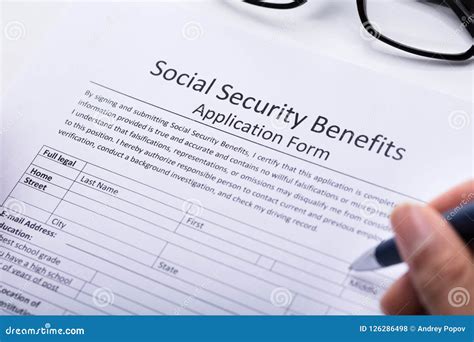 Person Filling Social Security Benefits Application Form Stock Photo ...