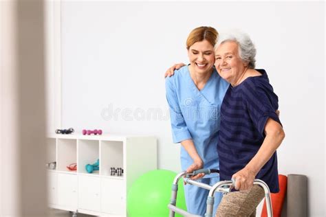 Caretaker Helping Elderly Woman with Walking Frame Stock Photo - Image of hospice, disabled ...