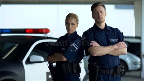 Confident Man and Woman Police Officers Standing Near Patrol Car ...