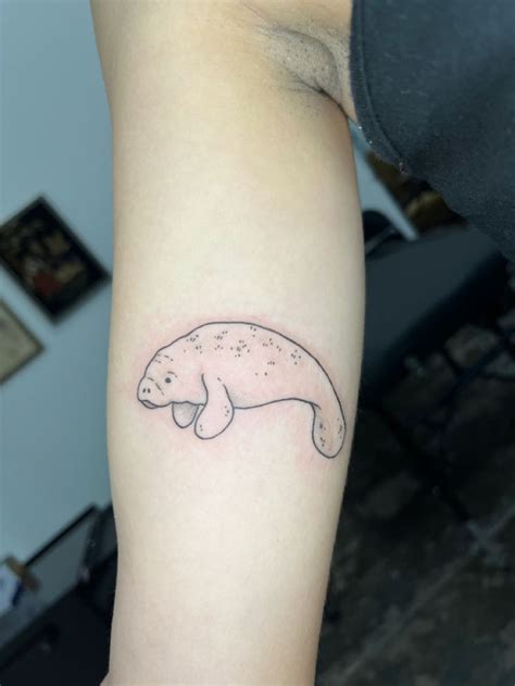 manatee arm tattoo in 2024 | Wrap around wrist tattoos, Discreet ...