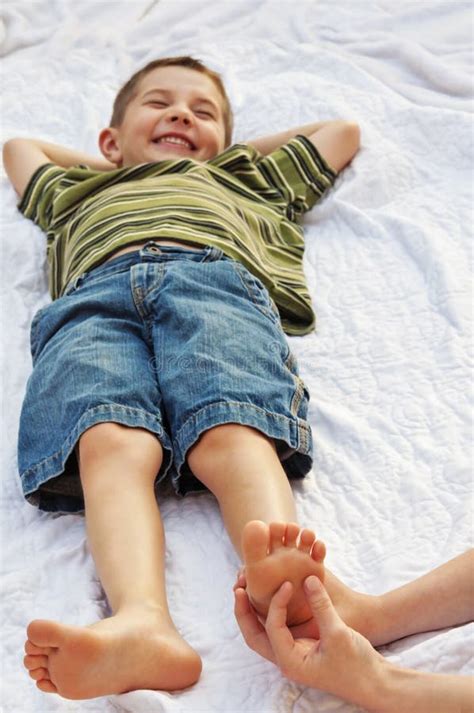 Child getting foot tickled stock photo. Image of giggling - 58174096