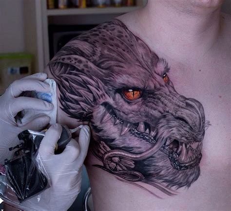 Realism Dragon done in b&g with fiery orange eyes. Tattooed by Alexander Suvorov, an artist base ...