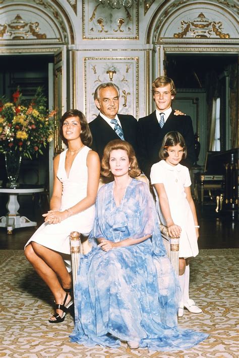 a family posing for a photo in an ornate room