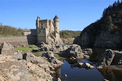 The Château de La Roche stands on an island in the lake formed by the ...