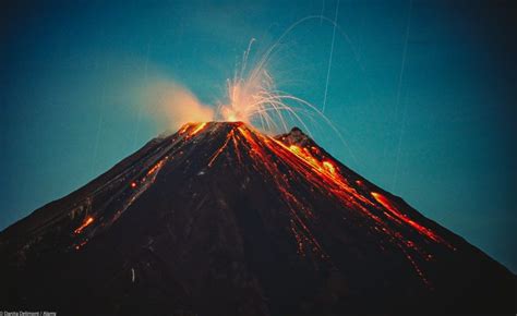 Central America, Costa Rica. Arenal Volcano erupting at night ...