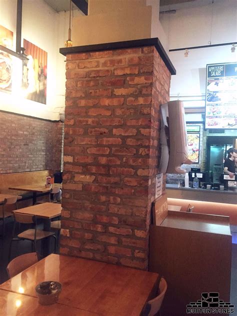 Installing brick veneers on a column in a restaurant. #mortonstones # ...