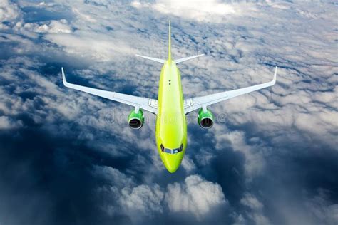 Green Passenger Plane Fly Over the Clouds. Front View. Stock Image ...