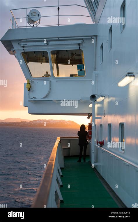 Norway, Finnmark, Kirkenes, sunrise since ship MS Nordkapp company Hurtigruten sails along ...