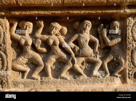 Dancing poses of Indian classical dance Bharatanatyam carved in stone wall of the outer prakaram ...