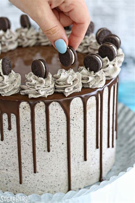 Cookies and Cream Cake - hand placing mini Oreo on top of cake | From SugarHero.com #chocol ...