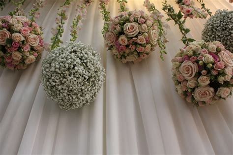 Hanging flower balls with trailing orchids and ivy | gypso and rose balls | stage backdrop ...