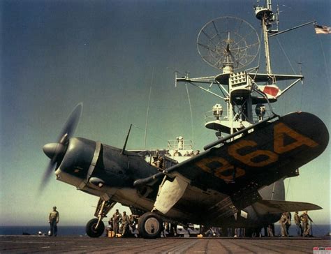 A Curtiss SB2C Helldiver revs up to take off from an aircraft carrier ...