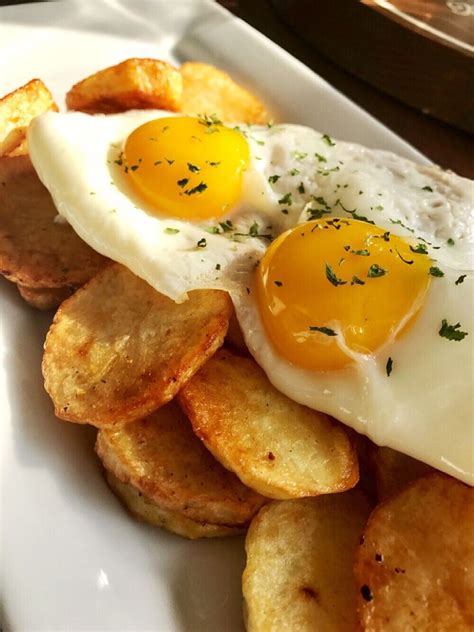 Fried eggs and potato slices