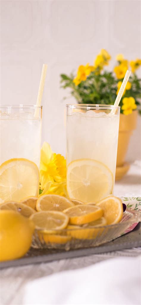 sliced lemon beside two clear drinking glasses iPhone Wallpapers Free Download