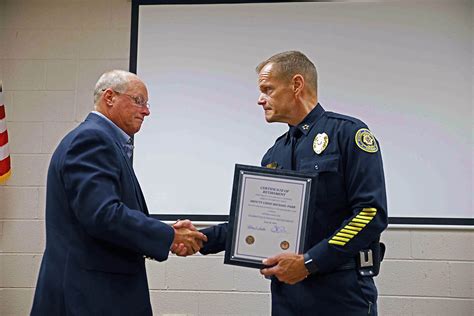 Clarksville Police Chief Al Ansley (R) shakes Deputy Chief Mike Parr (L ...