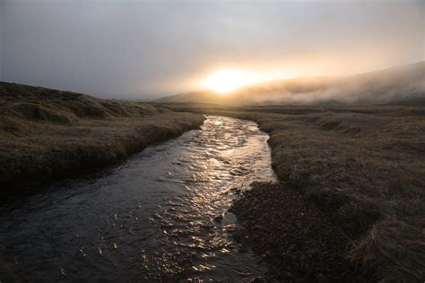 Calm river flowing on plain at sunset · Free Stock Photo