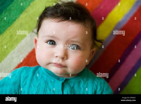 Beautiful Baby Girl with brown hair and blue eyes Stock Photo - Alamy