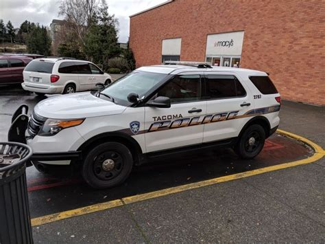 a white police car parked in front of a building