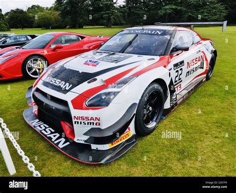 Nissan GTR race car next to a Ferrari 458 Stock Photo - Alamy